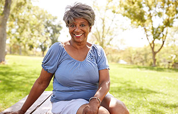 Smiling mature Afro-American woman in the park.