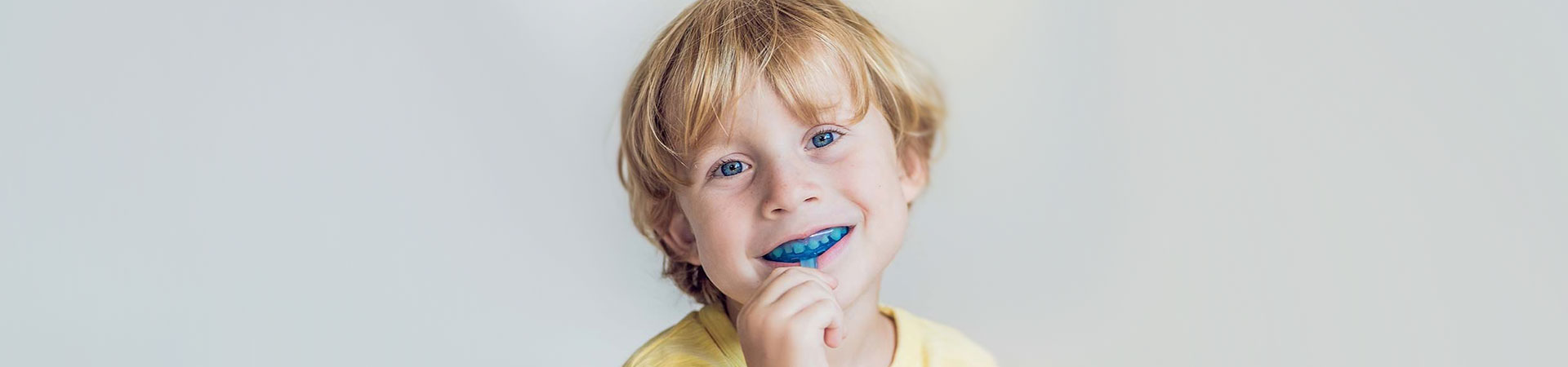 Boy with nightguard in his mouth.