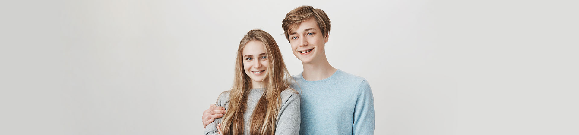 Happy siblings wearing braces. Orthodontic treatment Marietta, GA.