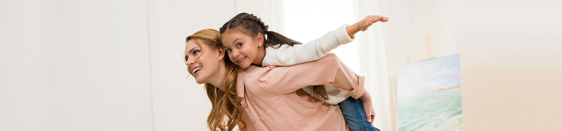 Mother giving piggyback her daughter.