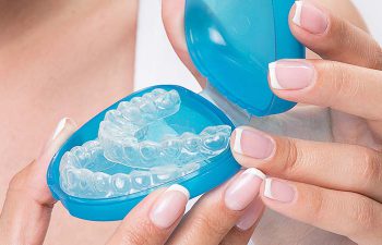 Woman showing invisible braces - Invisalign.