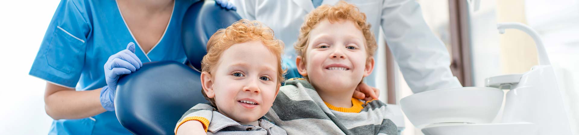 Twin boys in a dental chair.